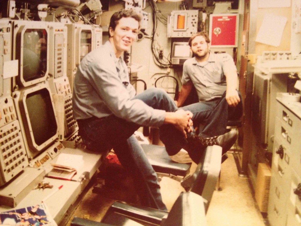 The sonar control room on Bremerton around 1983. Sonar Technician's William D'Happart and Jeff Marcey enjoying a rare photo opportunity inport between working on the gear. - photo by Challen Yee