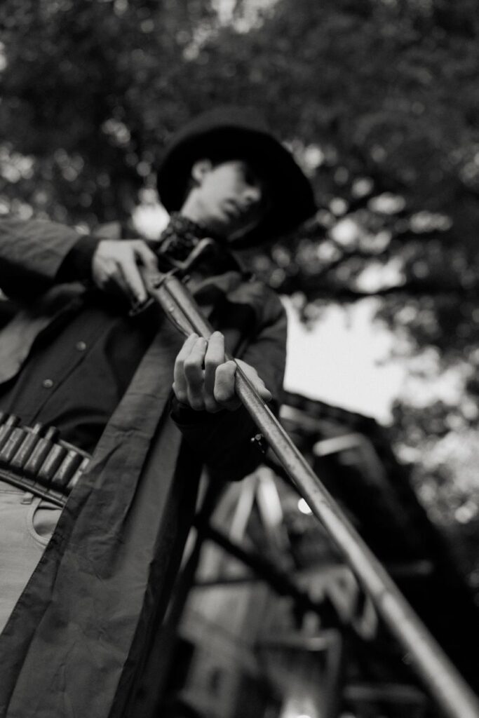 dramatic black and white cowboy with rifle