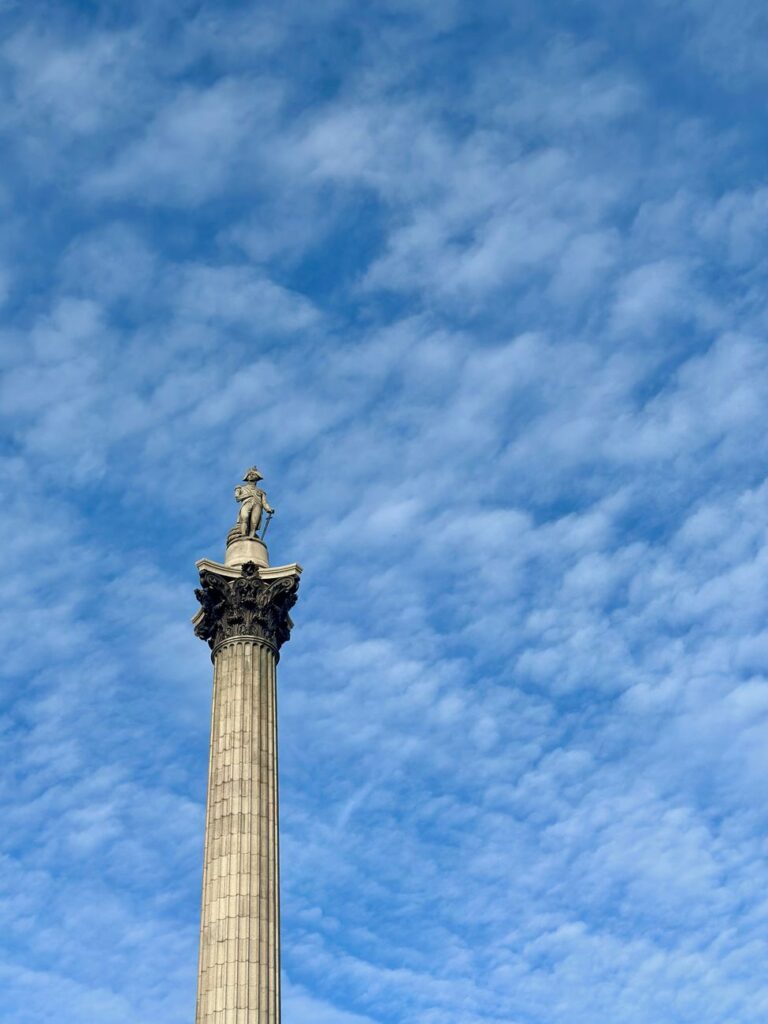 nelson s column against a bright blue sky. Lord Nelson is perhaps the greatest and most admired Naval Hero in the history of England.