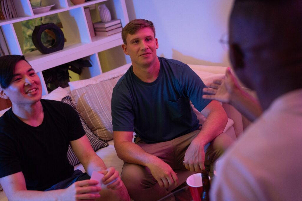 two men sitting on a sofa