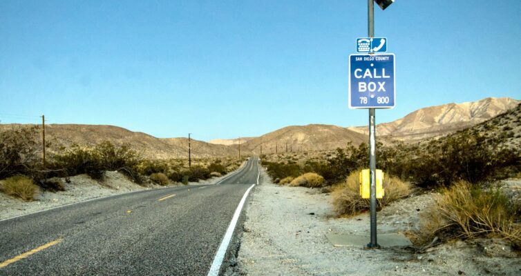 lonely desert highway with call box in california