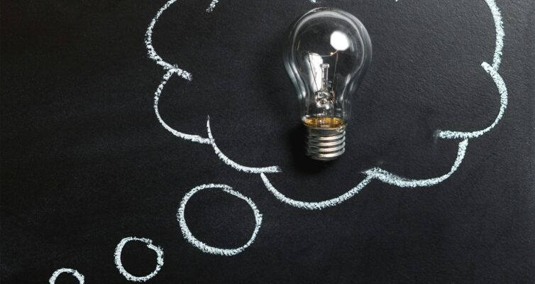 clear light bulb placed on chalkboard