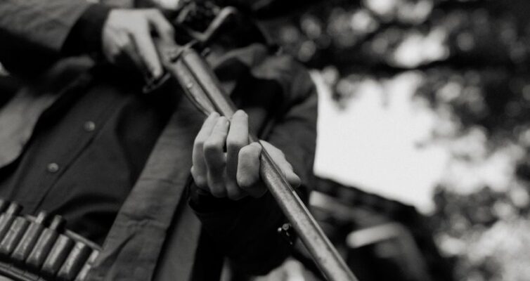 dramatic black and white cowboy with rifle