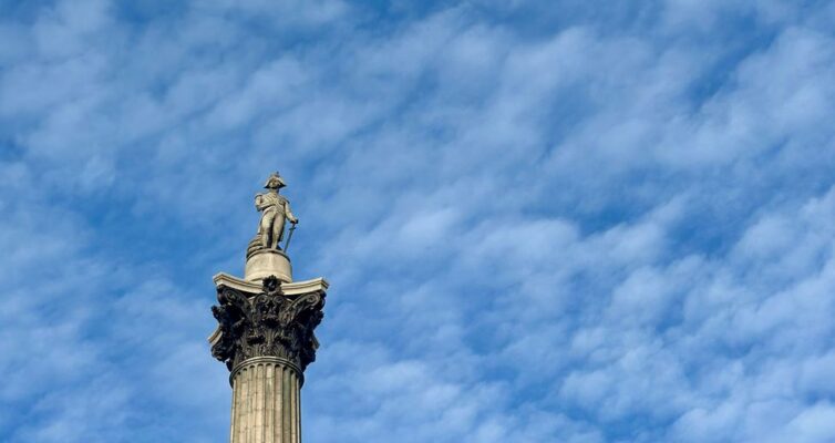 nelson s column against a bright blue sky. Lord Nelson is perhaps the greatest and most admired Naval Hero in the history of England.