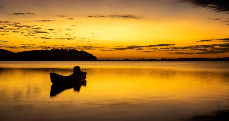 silhouette of a boat during sunset